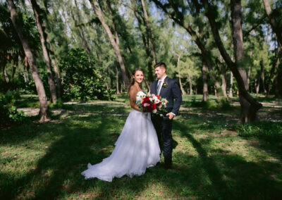 Photo of a bride and groom under the Australian pine trees.